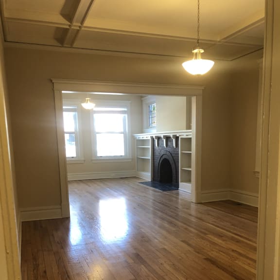 the view from the top of a staircase looking down into a hallway with a window