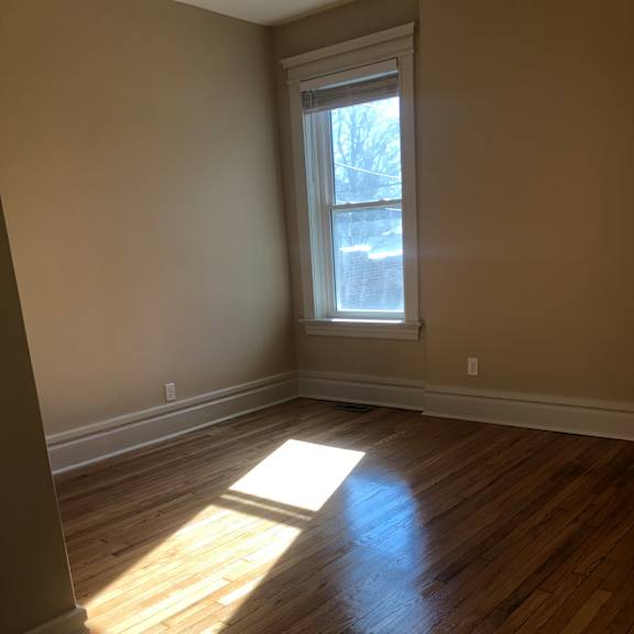the view of a window in a room with a wooden floor
