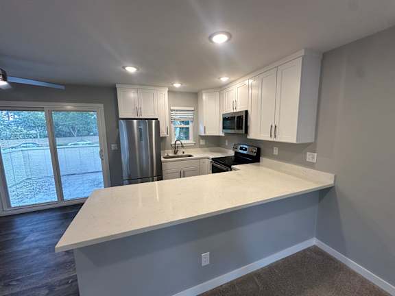 a kitchen with a sink and a stove and a refrigerator