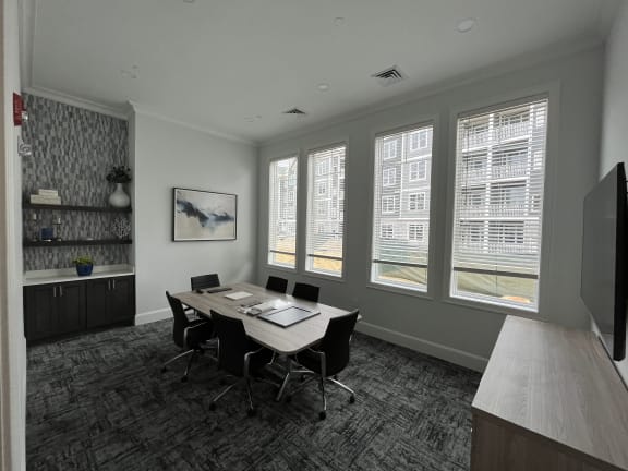 a room with a table and chairs and a wall of windows at The Oasis at Plymouth, Massachusetts