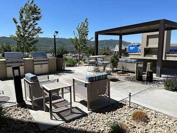A modern outdoor seating area with a view of the mountains.