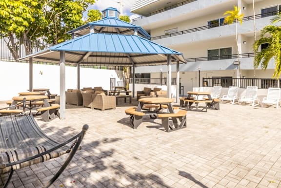 a small white house with a driveway and palm trees at Lakeside @ Biscayne Gardens,North Miami, FL,33181