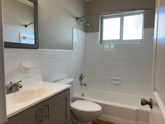 an empty bathroom with a sink toilet and tub  at Palm Gardens @ Biscayne Gardens, North Miami, FL