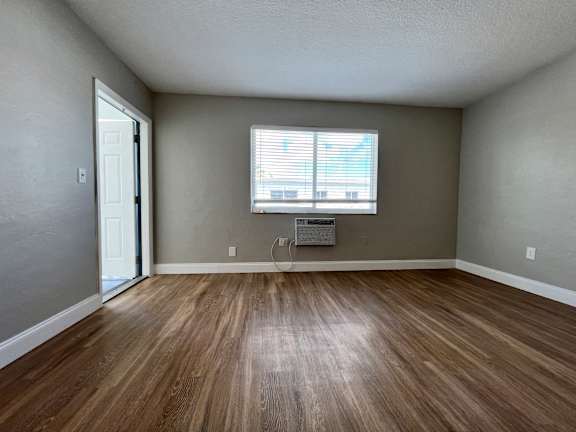 an empty room with a window and a wood ceiling  at Palm Gardens @ Biscayne Gardens, North Miami, FL