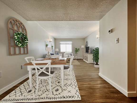 a living room and dining room with a table and chairs and a rug  at Palm Gardens @ Biscayne Gardens, North Miami, FL