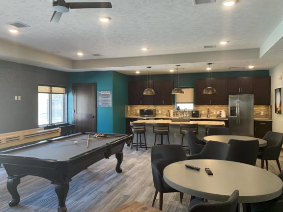 Clubhouse kitchen with ample seating and pool table to the left