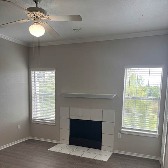 a bathroom with a tv on the wall and a window