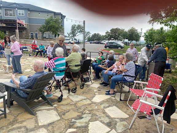a group of people sitting in chairs on a patio at LIV at Boerne Hills an Active Senior Community 62+, Boerne, TX, 78006