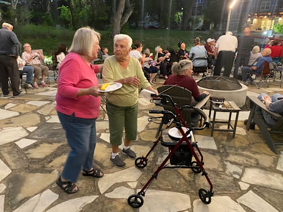 two people are talking at an outdoor event with a stroller at LIV at Boerne Hills an Active Senior Community 62+, Boerne, TX, 78006