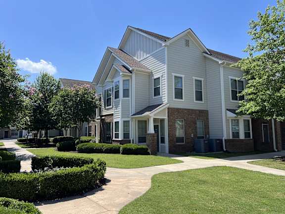 a bedroom with a large bed and a ceiling fan at Audubon Park Apartment Homes, Louisiana, 70791