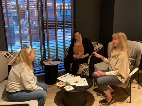 a group of women sitting around a table
