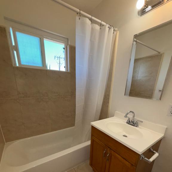A bathroom with a window and a sink.
