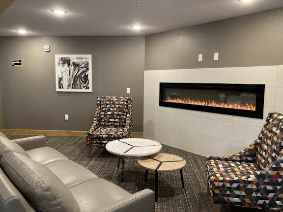 a living room with couches and chairs and a fireplace