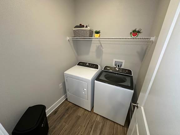 A small laundry room with a washer and dryer.