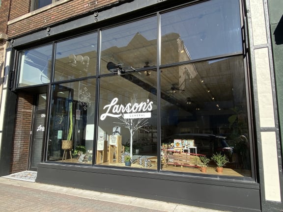 a window display of a store called lansons in a brick building