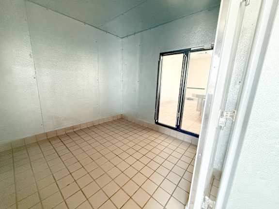 A room with a tiled floor and a sliding glass door.