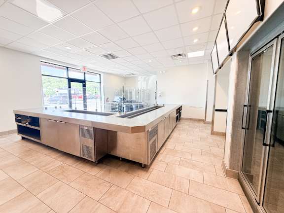 A kitchen with a counter and a window.