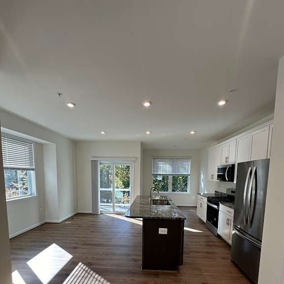 A modern interior with wooden walls and a skylight.