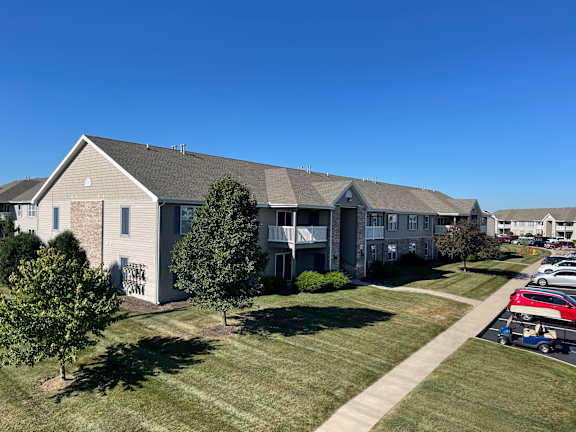 an aerial view of an apartment building with grass and trees  at Hawthorne Properties in Lafayette, IN 47905