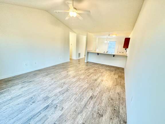 the living room and dining room of an empty home with wood flooring at Hawthorne Properties in Lafayette, IN 47905