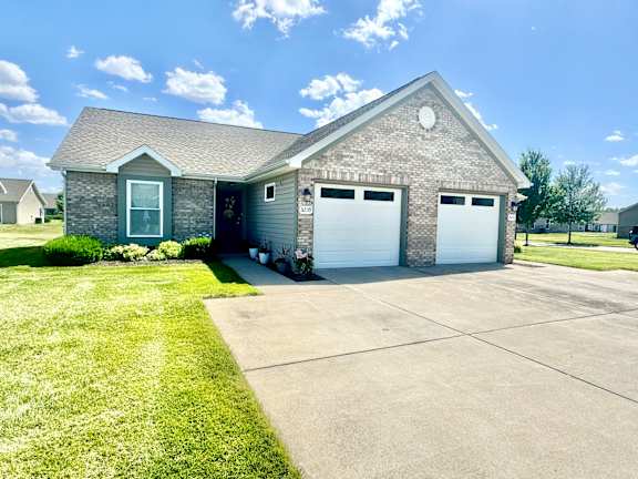 a gray brick house with a white garage door at Hawthorne Properties in Lafayette, IN 47905