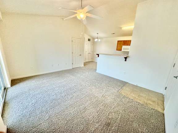 the living room of an empty house with a ceiling fan  at Hawthorne Properties in Lafayette, IN 47905