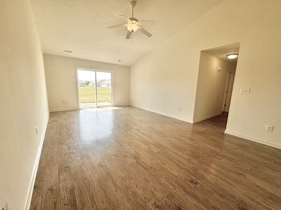 an empty living room with hardwood flooring and a ceiling fan  at Hawthorne Properties in Lafayette, IN 47905