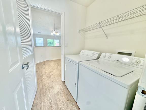 a laundry room with a washer and dryer and a door to a closet at Hawthorne Properties in Lafayette, IN 47905