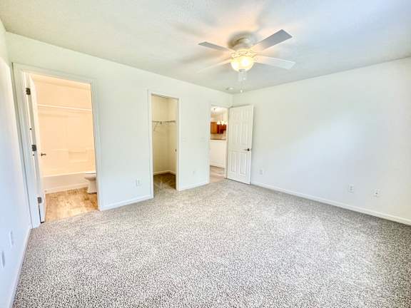 the living room of an empty home with a ceiling fan at Hawthorne Properties in Lafayette, IN 47905