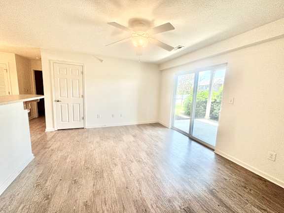 an empty living room with a ceiling fan  at Hawthorne Properties in Lafayette, IN 47905