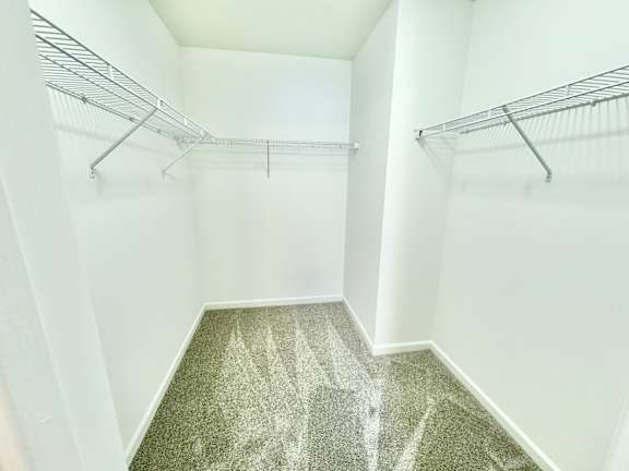an empty closet with empty shelves in a room with white walls  at Hawthorne Properties in Lafayette, IN 47905
