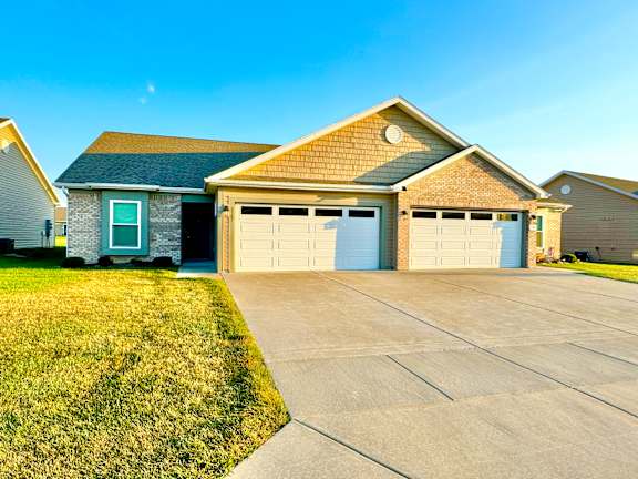 a house with a driveway and a garage door  at Hawthorne Properties in Lafayette, IN 47905
