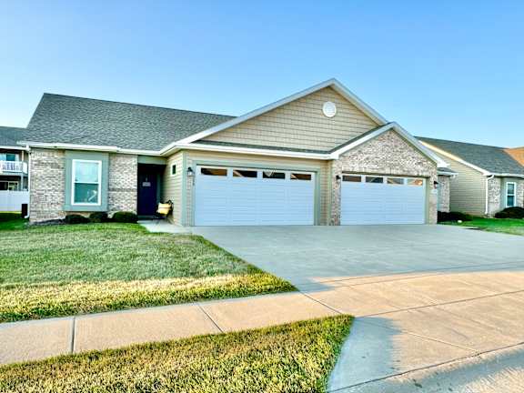 a house with two garage doors and a driveway  at Hawthorne Properties in Lafayette, IN 47905