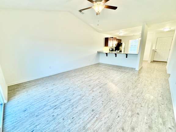 an empty living room with white walls and a ceiling fan at Hawthorne Properties in Lafayette, IN 47905