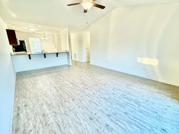 an empty living room with white walls and a ceiling fan at Hawthorne Properties in Lafayette, IN 47905