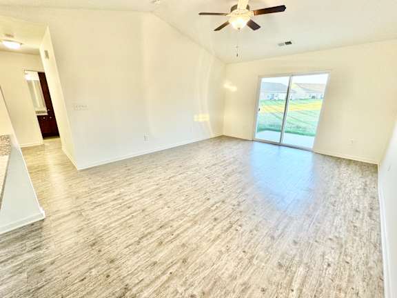 an empty living room with white walls and a ceiling fan at Hawthorne Properties in Lafayette, IN 47905