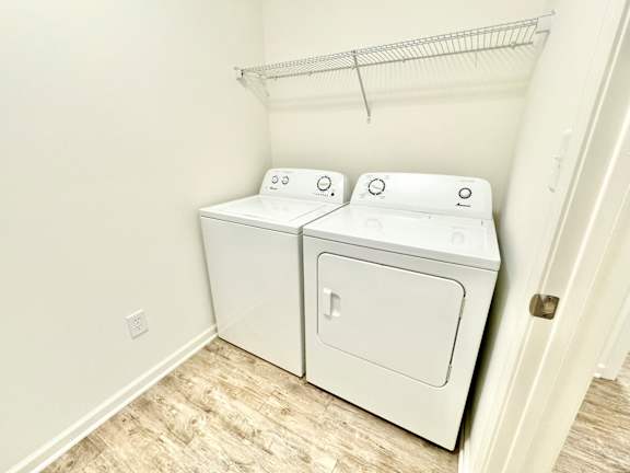 the laundry room has a washer and dryer and a shelf over the door at Hawthorne Properties in Lafayette, IN 47905