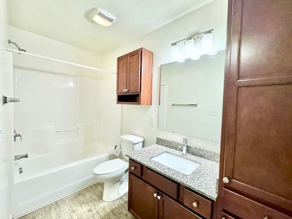 a bathroom with a sink toilet and a mirror at Hawthorne Properties in Lafayette, IN 47905