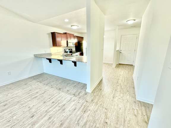 a view of a kitchen and living room in a new home at Hawthorne Properties in Lafayette, IN 47905