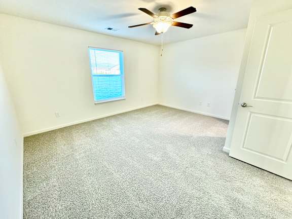 an empty room with a ceiling fan and a window at Hawthorne Properties in Lafayette, IN 47905