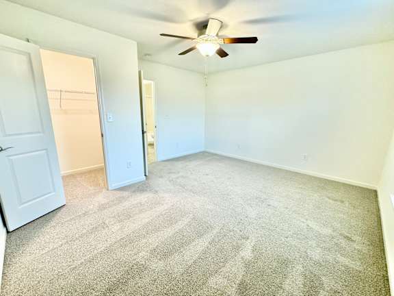 the living room of an empty home with a ceiling fan at Hawthorne Properties in Lafayette, IN 47905