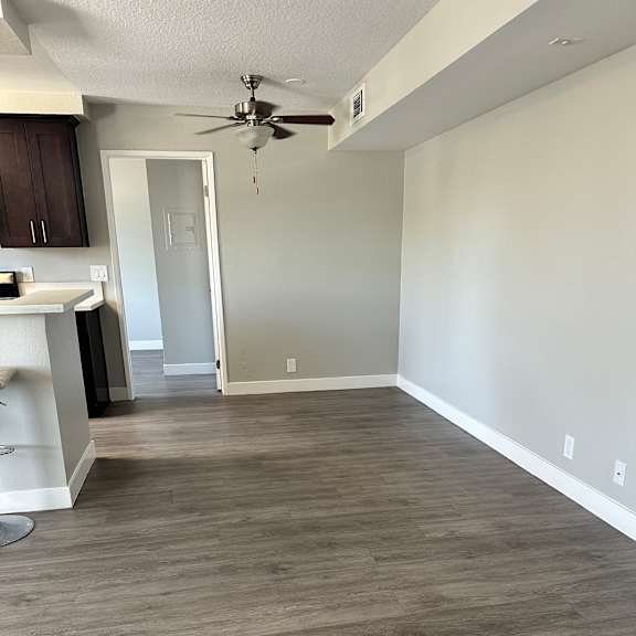 A modern kitchen with a fan on the wall.