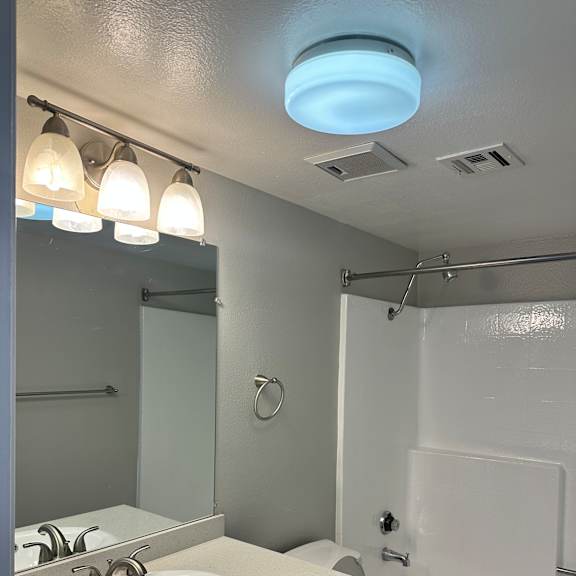 A bathroom with a toilet, sink, and shower.