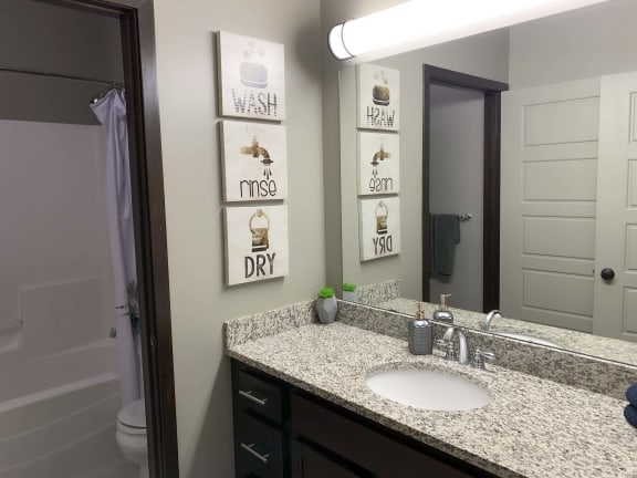 Bathroom with granite countertop at North Pointe Villas