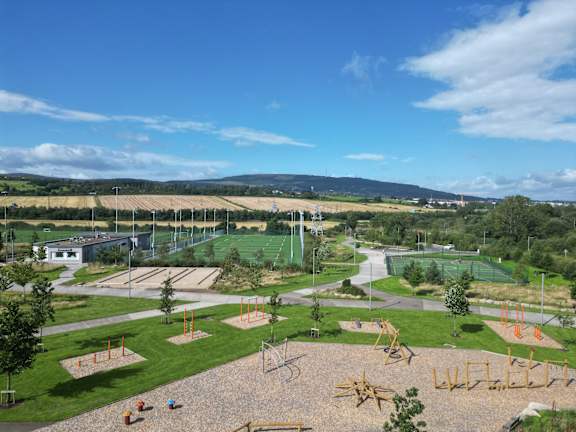 A playground with a swing set and a slide.