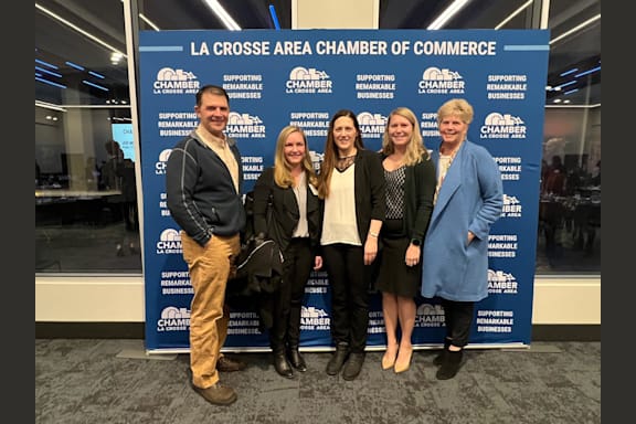 a group of people standing in front of a sign