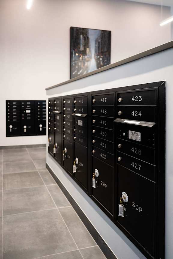 A row of black mailboxes with numbers 417 to 427 and 30P.