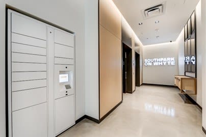 a large hallway with white cabinets and a vending machine at Southpark on Whyte, Edmonton, Alberta