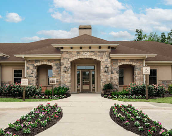 A building with a stone facade and a large arched entrance.