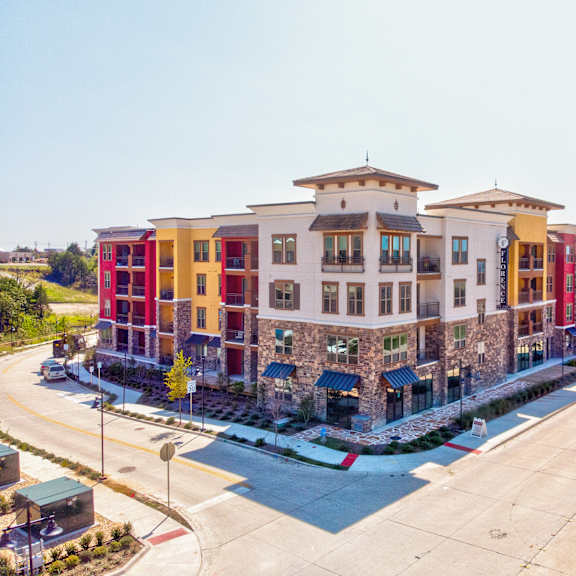An exterior arial shot of Florence on the Harbor showing the colorful building and surrounding street. 